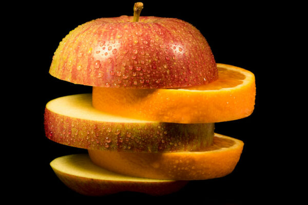 Increase Respect for Differences: Image is apple and orange slices alternating in a stack.