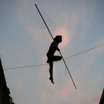 Extreme Leadership: Image is person on high wire w/ balance pole.