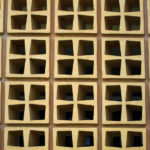Business Empathy: Image is cinder blocks arranged in pattern with openings for change.