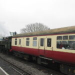 Endings Transitions Beginnings: Image is a steam train car.