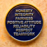 Great employee attitude: Image is a coin saying traits of great attitude.