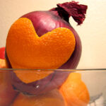Misguided Leadership Belief: Image is an onion w/ an orange peel attached in the shape of a heart.