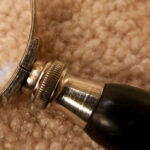 Nit-Picking Know-It-All Leader: Image is magnifying glass on a carpet.