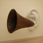 Customer Cues: Image is an ear trumpet near an ear.