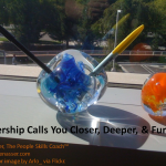 Leadership Calls: Image is paper weight on desk w/ pens sticking out of it.